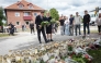 Swedish Prime Minister Ulf Kristersson and Social Democratic Party leader Magdalena Andersson visit the makeshift memorial outside a school in Fagersta, central Sweden, on August 22, 2026, a day after a 17-year-old girl was killed and three other people were injured in a sword attack at the school. Photo by Magnus LEJHALL / TT NEWS AGENCY / AFP