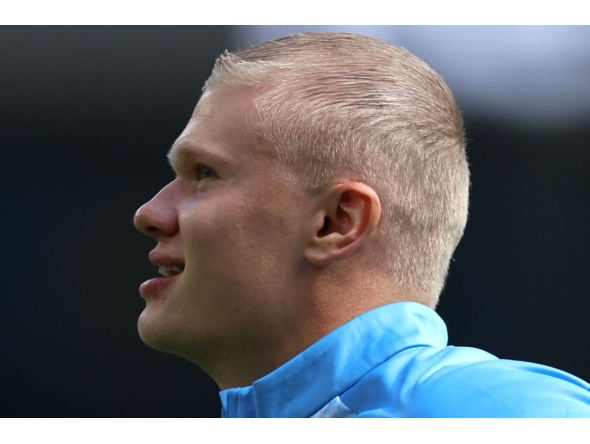 Manchester City's Norwegian striker #09 Erling Haaland, sporting a new hair cut, warms up ahead of the English Premier League football match between Manchester City and AFC Bournemouth at the Etihad Stadium in Manchester, north west England, on August 23, 2026. (Photo by Darren Staples / AFP) 