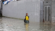 A student stands in floodwater in Quezon City, the Philippines, on Aug. 17, 2026. (Xinhua/Rouelle Umali)
