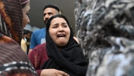 A mother reacts after the death of her child following a fire incident outside the Mother and Child Health (MCH) ward at the Pakistan Institute of Medical Sciences (PIMS) Hospital in Islamabad on August 26, 2026. (Photo by Aamir QURESHI / AFP)