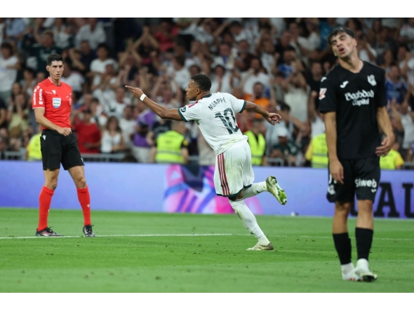 Real Madrid's French forward #10 Kylian Mbappe celebrates scoring his team's first goal during the Spanish league football match between Real Madrid CF and Real Sociedad at Santiago Bernabeu Stadium in Madrid on August 26, 2026. (Photo by Thomas COEX / AFP)
