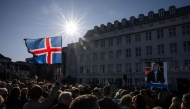 A participant waves an Icelandic flag during a rally of supporters of the 'No' campaign against reopening Iceland's European Union accession negotiations in Reykjavik, Iceland, on August 27, 2026, two days ahead of a national referendum. Icelanders will vote on August 29 on whether the country should resume EU accession negotiations, which were suspended in 2013. (Photo by Jonathan NACKSTRAND / AFP)