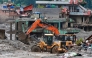 Workers use excavators to clear the mud at the Dhunge Bazaar in Nepal's Nuwakot district on August 29, 2026 after flash floods and landslides hit the Nepal-Tibet border. (Photo by PRABIN RANABHAT / AFP)