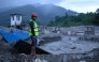 A disaster rescue personnel looks on at the site of damaged buildings in the aftermath of flash floods at Trishuli Bazar in Nepal's Nuwakot district on August 29, 2026. (Photo by MANAN VATSYAYANA / AFP)