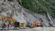 Workers use excavators to clear debris and rebuild the mudslide-damaged road which leads to Gyirong Port in Gyirong County, in China's western Tibet region on August 30, 2026. Photo by CNS / AFP