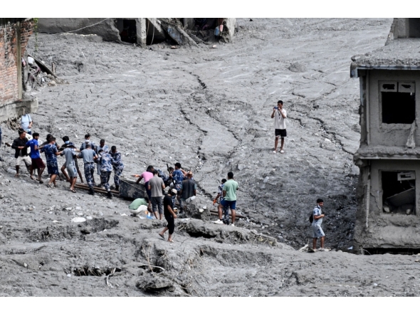 Rescue personnel pull out a locker from a deluged bank after flash floods at Trishuli Center in Nepal's Nuwakot district on September 1, 2026. T(Photo by Arun SANKAR / AFP)