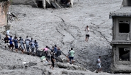 Rescue personnel pull out a locker from a deluged bank after flash floods at Trishuli Center in Nepal's Nuwakot district on September 1, 2026. T(Photo by Arun SANKAR / AFP)
