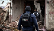 A State Police officer walks amid remains caused by a car bomb explosion outside the municipal police station in Ojocaliente, Zacatecas, Mexico, on August 31, 2026. Photo by JESS MIRELES / AFP