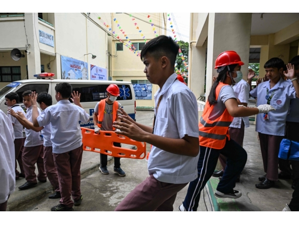 Students raise their hands as they evacuate during a nationwide school drills to safeguard students from armed intruders, at a school in San Rafael, Bulacan on September 3, 2026. (Photo by Jam STA ROSA / AFP)