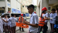 Students raise their hands as they evacuate during a nationwide school drills to safeguard students from armed intruders, at a school in San Rafael, Bulacan on September 3, 2026. (Photo by Jam STA ROSA / AFP)