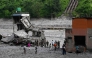 Security and relief personnel stand along the Trishuli riverbank in the aftermath of flash floods at Trishuli Bazar in Nepal's Nuwakot district on September 5, 2026. (Photo by Prakash MATHEMA / AFP)