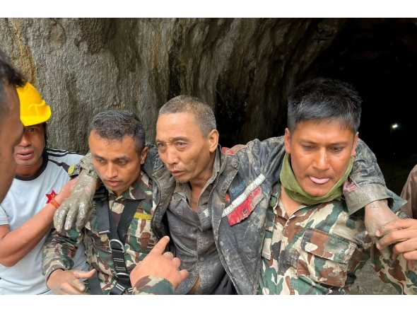 This handout photograph taken and released on September 5, 2026 via the Facebook page of Nepal Army shows security personnel carrying a Chinese national (2R) rescued from the Audit Tunnel 4 of the Upper Trishuli-1 Hydropower Project site in Nepal's Rasuwa district. (Photo by Handout / Nepal Army Facebook Page / AFP)