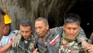 This handout photograph taken and released on September 5, 2026 via the Facebook page of Nepal Army shows security personnel carrying a Chinese national (2R) rescued from the Audit Tunnel 4 of the Upper Trishuli-1 Hydropower Project site in Nepal's Rasuwa district. (Photo by Handout / Nepal Army Facebook Page / AFP)