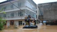 A member of a search and rescue team evacuates people from floods affected area following heavy rains in Suichuan, Central China's Jiangxi province on September 4, 2026. (Photo by CN-STR / AFP) / China OUT