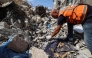 A Civil Defence member collects human remains in the rubble of Al-Muhandisin Tower, that was destroyed in Israeli strikes in the Nuseirat camp for refugees in the central Gaza Strip on September 5, 2026. (Photo by Eyad BABA / AFP)