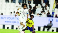 Al Sadd's Akram Afif (left) controls the ball.