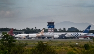 Airplanes sit on the tarmac at Iskandar Muda airport in Blang Bintang on September 6, 2026. Indonesia halted operations at its main international airport outside Jakarta on September 6, after ash spewed from the Anak Krakatoa volcano more than 150 kilometres away, impacting thousands of passengers. (Photo by CHAIDEER MAHYUDDIN / AFP)