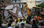 Bulldozers clear debris as rescue personnel conduct a search operation at the site following a building collapse in the Satya Niketan area in New Delhi on September 6, 2026. (Photo by Sajjad HUSSAIN / AFP)