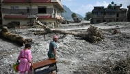 People recover their belongings in the aftermath of flash floods at Devighat in Nepal's Nuwakot district on September 8, 2026. Photo by Pedro PARDO / AFP