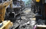 A man operates a backhoe to clean a street in the aftermath of flash floods at Devighat in Nepal's Nuwakot district on September 8, 2026. Photo by Pedro PARDO / AFP