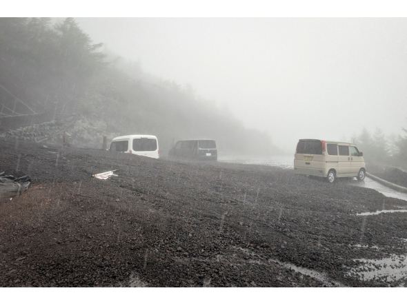 This handout photo taken on September 9, 2026 and received from Shizuoka prefecture on September 10, 2026 shows vehicles buried by mud and debris after a landslide swept into the parking lot at Fifth Station of Mount Fuji's Fujinomiya Trail in Fujinomiya, Shizuoka Prefecture. (Photo by Shizuoka Prefecture / AFP)