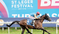 Tom Marquand rides Romeo At during the race.