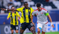 Al Shamal's Baghdad Bounedjah (right) and Al Ittihad's Dion Lopy vie for the ball.