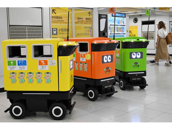 Mobile robotic trash bins are pictured during testing at the Shinjuku Station transport complex in Tokyo on September 18, 2026. Photo by Toshifumi KITAMURA / AFP