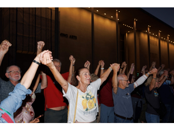 Demonstrators hold hands to form a human chain during a rally outside the John F. Kennedy Center for the Performing Arts on September 18, 2026 in Washington, DC. Tom Brenner/Getty Images/AFP 
 