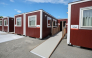 This picture taken on August 26, 2026 and released on September 18, 2026, shows temporary container huts being used to house athletes for the 2026 Asian Games at the Garden Pier in Nagoya. (Photo by JIJI Press / AFP) 