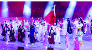 Mohammed Saadon Al Kuwari and Reem Al Sharshani carry the national flag as Qatari athletes march during the opening ceremony.


