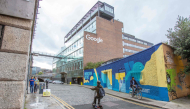  Members of the public pass the offices of Google in the business and financial sector of Dublin, Ireland on October 7, 2021. Photo by PAUL FAITH / AFP