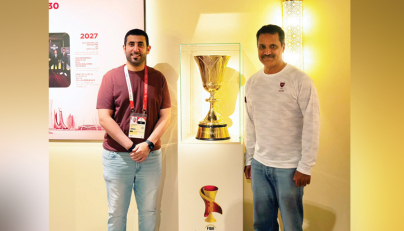 Qatar rally driver and Olympic bronze medallist in shooting Nasser Al Attiyah (right) poses with the Naismith Trophy at the Qatar House in Nagoya, yesterday.