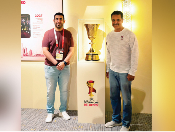 Qatar rally driver and Olympic bronze medallist in shooting Nasser Al Attiyah (right) poses with the Naismith Trophy at the Qatar House in Nagoya, yesterday.