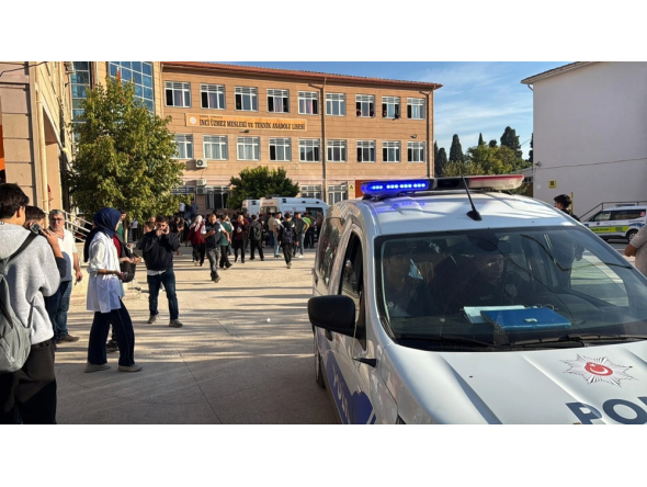 This handout photograph taken and released on September 22,2026 by Turkish news agency DHA (Demiroren News Agency) shows ambulances and police officers waiting in front of a high school outside which a gunman opened fire wounding eight people, and was detained shortly afterwards, in Turgutlu, an area west of the resort city of Izmir. (Photo by Handout / DHA (Demiroren News Agency) / AFP)