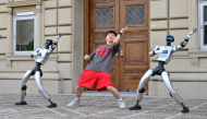Chinese street dancer Wu Yufei performs alongside Unitree Robotics humanoid robots during a demonstration in Pasadena, California, on September 17, 2026. Photo by Frederic J. Brown / AFP