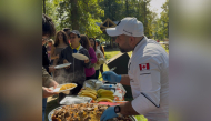 Community members enjoy Qatari dishes at the event. 