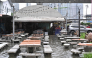 A man looks out from a flooded restaurant in Bangkok on September 26, 2026. (Photo by Lillian Suwanrumpha / AFP)