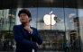 A man looks on as he walks past an Apple store in Beijing on September 23, 2026. (Photo by WANG Zhao / AFP)
