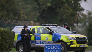 Armed police man a roadblock while posted outside RAF Fairford base in Fairford, south-west England on September 27, 2026, as UK counter-terrorism police investigate an incident near the base in the village of Whelford. Photo by JUSTIN TALLIS / AFP