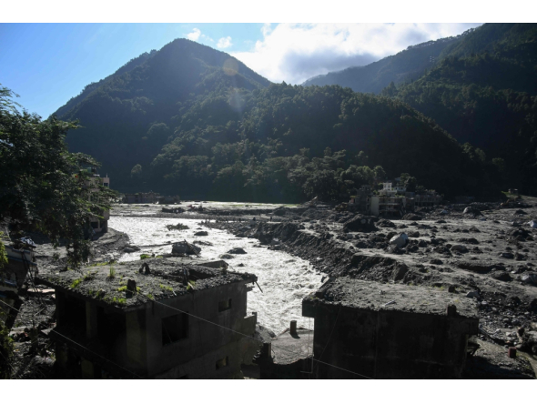 A general view shows damaged houses covered in sludge in the aftermath of the August 26 flash flood, at Betrawati Bazaar in Nepal's Rasuwa district on September 28, 2026. (Photo by Prakash Mathema / AFP)