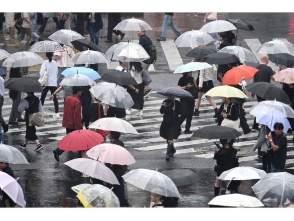 (Files) Pedestrians with umbrellas walk on a crossing as rain falls in Tokyo's Shibuya district on September 20, 2026. (Photo by Rie Kikuchi / AFP)