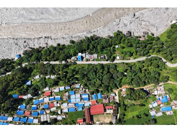 An aerial view shows damaged houses covered in sludge in the aftermath of the August 26 flash flood, at Betrawati Bazaar in Nepal's Rasuwa district on September 28, 2026.  (Photo by PRAKASH MATHEMA / AFP)