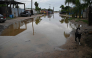 A dog walks down a flooded street following the arrival of Hurricane Polo in the town of Puerto San Carlos, Baja California Sur, Mexico, on September 29, 2026. (Photo by Carl de Souza / AFP)