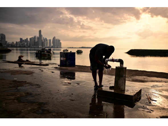 A fisherman washes at the fishing terminal in Panama City in the early hours of the morning on September 24, 2026. (Photo by Martin Bernetti / AFP)