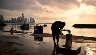 A fisherman washes at the fishing terminal in Panama City in the early hours of the morning on September 24, 2026. (Photo by Martin Bernetti / AFP)
