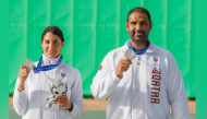 Qatar's Ray Bassil and Mohammed Al-Rumaihi celebrate with their medals on the podium. 