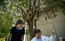 In this picture taken on August 25, 2026, activists Kaoru Morimoto (L) and Susumu Nirasawa check the temperature under a tree in the Nakano district of Tokyo. (Photo by Philip Fong / AFP)
