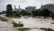 The swollen Besos River flows through Sant Adria de Besos following torrential rains on the outskirts of Barcelona, on October 4, 2026. (Photo by Josep Lago / AFP)