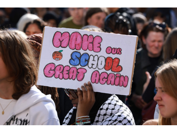 A high school student holds a placard during a gathering amid a nationwide protest movement over school conditions in Saint-Denis, north of Paris, on October 4, 2026. Photo by Kenzo TRIBOUILLARD / AFP
